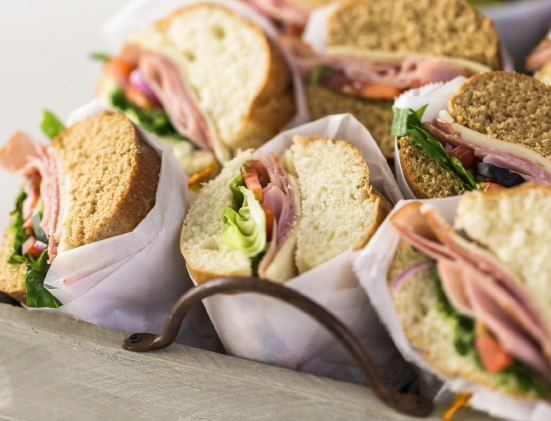 Assorted deli sandwich tray prepared for graduation lunch catering, featuring fresh breads, meats, and vegetables for an open house celebration in Columbus