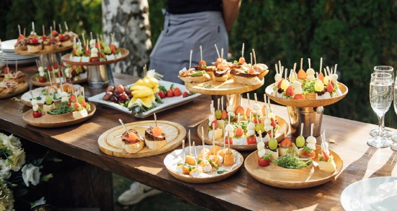 Outdoor wedding catering display with assorted appetizers and hors d'oeuvres arranged for guests in Powell, Ohio.