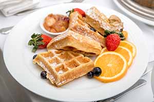 Waffles, French toast and fruit slices from a breakfast catering menu