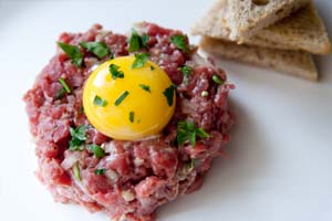 beef tartar with raw egg from a catering meny