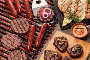 Outdoor cookout catering with hot dogs and hamburgers on a grill